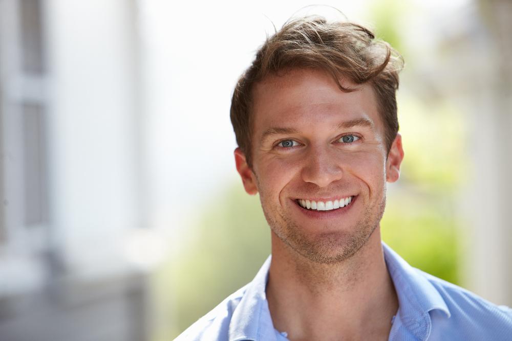 man in blue shirt smiling | emergency dentist sydney