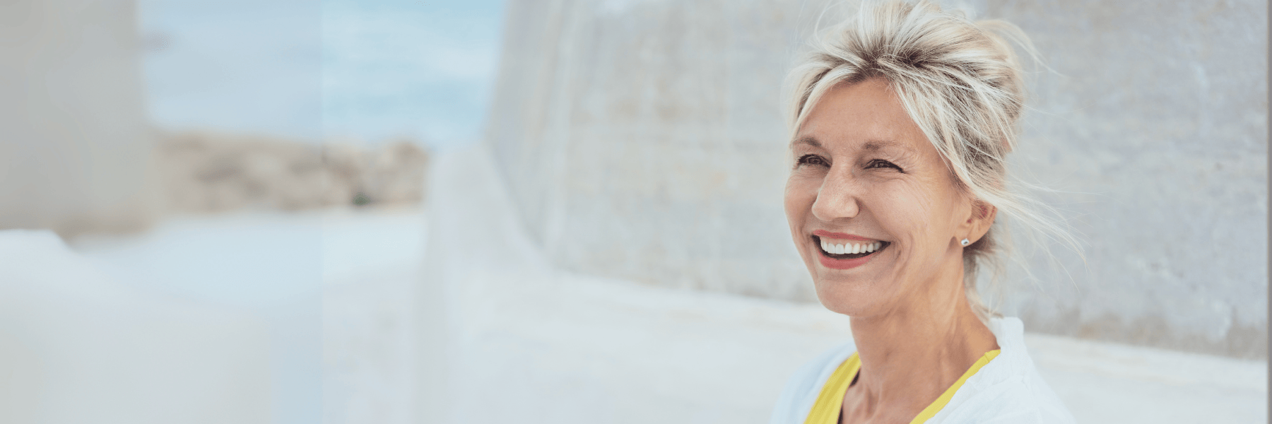 Middle-aged woman smiling confidently after receiving emergency dental care in Sydney