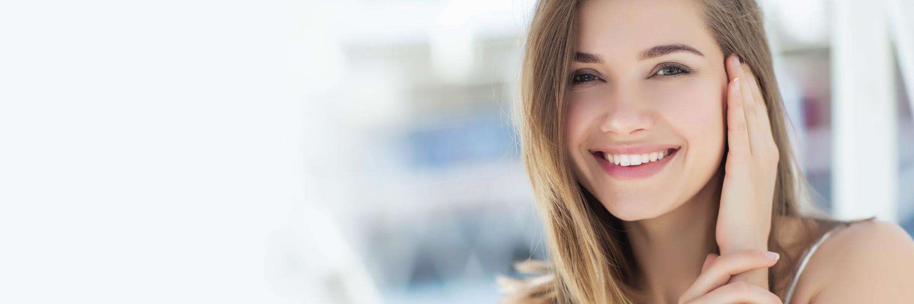 woman with brown hair smiling | neutral bay root canal treatment